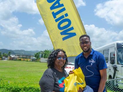 Omar Wright (right), lead, Environment and Community Development at the JN Foundation, presents a care package to Norma Fenton, president of the Petersfield Galloway Benevolent Society during a medical mission to the community, recently. The JN Foundation 