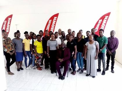 Member of Parliament for St Mary South Eastern Christopher Brown (seated) with tertiary-level students who received educational grants during the presentation ceremony.