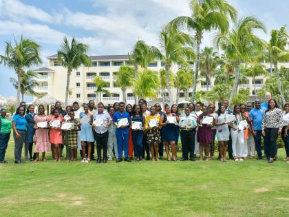 Staff members and parents of the Iberostar Rose Hall team join the 15 awardees of the hotel’s PEP Scholarship Programme and Back-to-School Book Initiative for a group photo following the presentation ceremony.