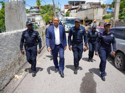Acting Commissioner of Police Clifford Blake and senior police officers from Area One and St James touring sections of Crawford Street in Mt Salem yesterday.