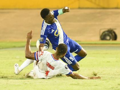 Daniel Green of Mount Pleasant is brought down by Steven Young of Portmore United during their 2026 Concacaf Caribbean Cup football match at the National Stadium on Wednesday night. Mount Pleasant won 1-0. - Ian Allen photo