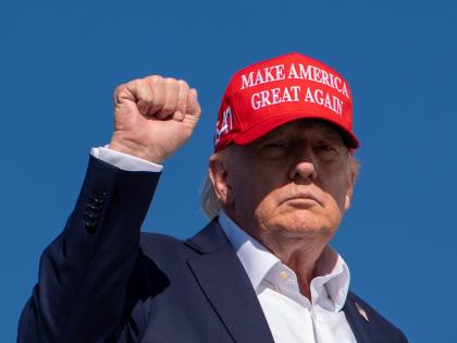 US President Donald Trump gestures while boarding Air Force One at Morristown Airport in Morristown, New Jersey.