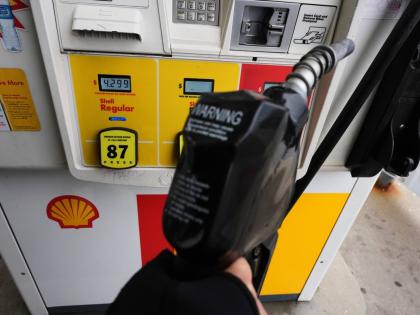 AP
A gas price is displayed as a customer holds a fuel pump nozzle before filling up her vehicle’s gas tank in Lincolnshire, Illnois, on April 15.  