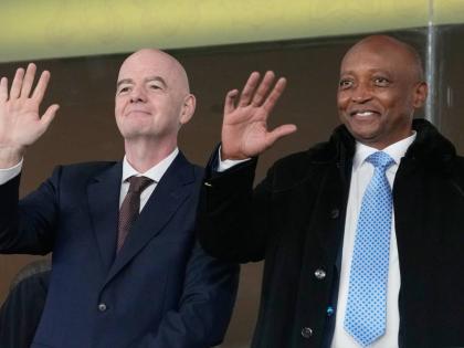 CAF President Patrice Motsepe and FIFA President Gianni Infantino wave from the tribune during the Africa Cup of Nations round-of-16 football match between South Africa and Cameroon in Rabat, Morocco, Sunday, January 4.