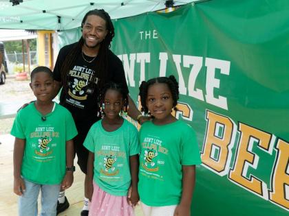 In between the day’s spell-off rounds, organiser Kurtious Loney-Walsh joins competition entrants (from left) eight-year-old Kassondre Walker, six-year-old Aria Gilmore and seven-year-old Kaliyah Vassell for a snapshot.