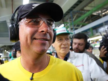 Opposition presidential candidate Senator Flavio Bolsonaro wears protective glasses and headphones during a visit to a Honda motorcycle factory in the Manaus Free Trade Zone during a campaign event in Manaus, Amazonas state, Brazil, Friday.