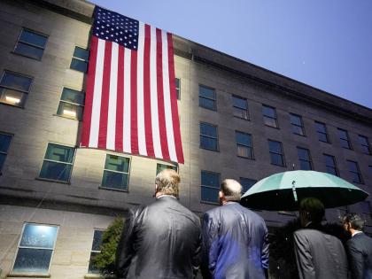 AP 
Secretary of Defense Pete Hegseth, chairman of the Joint Chiefs, Air Force General Dan Caine, and other officials, watch as the flag is unfurled at the Pentagon on September 11, 2026 in Arlington, Virginia.