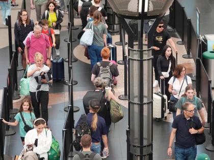 Travelers queue up to pass through the south security checkpoint in Denver International Airport in the USA on Wednesday, July 2, 2025. 