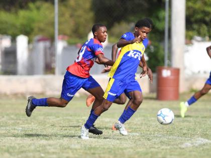 
Clan Cathy’s Amer Webb (left) chases Innswood’s Antoine Parkes during their ISSA Manning Cup football game at Alpha Boys’ Institute in Kingston yesterday. 