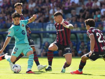 Barcelona’s Xavi Espart (left) scores his side’s first goal during the Spanish La Liga match between Levante and Barcelona in Valencia yesterday. 