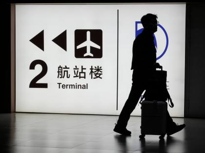 FILE - A passenger arrives at the Capital Airport in Beijing on Nov. 7, 2025. (AP Photo/Ng Han Guan, file)