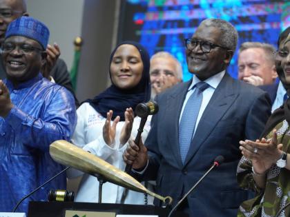 Nigerian industrialist Aliko Dangote (foreground, second right) flanked by executives and stakeholders at the Nigeria Stock Exchange. 