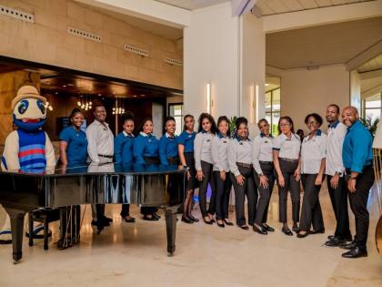 Staff at Royalton Blue Waters Trelawny pose for the camera as the resort accepts its first guests after 11 months of closure.