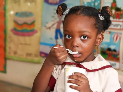 Kyra McCreath enjoys her meal on Tuesday as the Dream Big for Youth Foundation launched a breakfast programme at the Elite Basic School in Seaview Gardens, St Andrew. See story on Page A2.