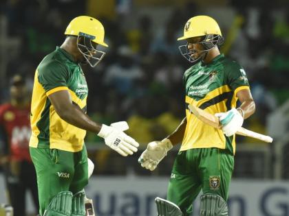 Keemo Paul (right) is congratulated by Rovman Powell after scoring 50 runs against the St. Kitts and Nevis Patriot in their Caribbean Premier League T20 Cricket match at Sabina Park in August.