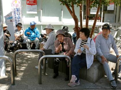 Elderly people rest under the shade of a tree in Tokyo, Japan. - AP file photo