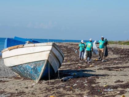 Volunteers work together to remove garbage from the Port Royal Beach as part of a beach clean-up activity hosted by the European Union Delegation to Jamaica, in recognition of an earlier International Coastal Clean-Up Day. 