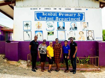 Maxcine Headley (third right), principal of Kendal Primary and Infant, and secretary for JN Circle Mandeville takes a group photo (from left), De’Ante Livingston of the JN Group; Cheryl Walker, teacher at Kendal Primary and Infant; Mildred Rattary, treas
