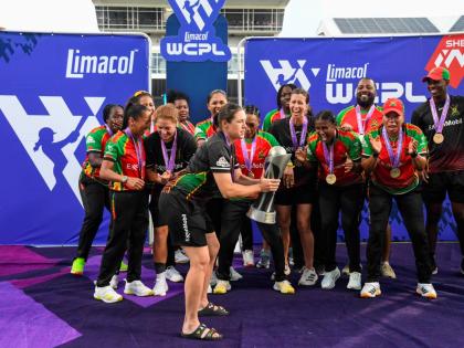 The Guyana Amazon Warriors Women celebrate winning the Limacol Women’s Caribbean Premier League after a two-wicket victory over the Trinbago Knight Riders at the Kensington Oval yesterday.