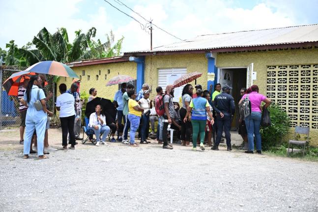 People are seen waiting in Edgewater to cast their votes.