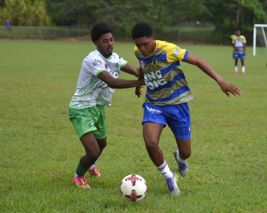 Maliek Headed of Rusea's High tries to shake from Frome Technical High's Jevani Plummer (left) during their ISSA daCosta Cup Zone B match at the Collin Miller Sports Complex in Lucea, Hanover on Tuesday, September 16. The match was called off owing to ligh