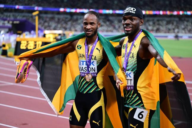 Silver medallist in the men’s 110m hurdles Orlando Bennett (right) and bronze medallist Tyler Mason celebrate on Day 4 of the World Athletics Championships in Tokyo, Japan.