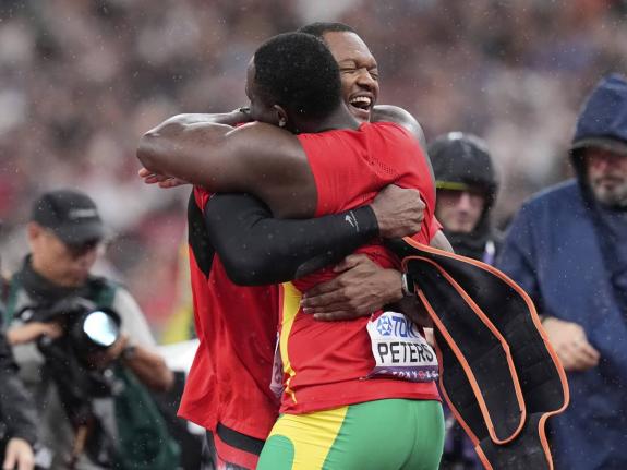 Gold medallist Keshorn Walcott of Trinidad and Tobago embraces silver medallist Anderson Peters of Grenada after the men’s javelin final at the World Athletics Championships in the Japan National Stadium in Tokyo, Japan, yesterday.