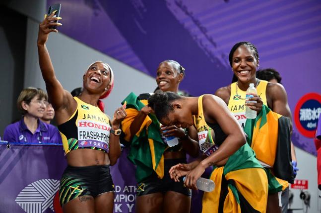 Shelly-Ann Fraser-Prycee (left) celerates her 17th World Championship medal, a silver in the women's 4x100 metres, by taking a selfie with her teammates from left: Tina Clayton, Tia Clayton, and Jonielle Smih.