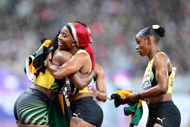 Jamaica’s Jonielle Smith (left) hugs Shelly-Ann Fraser-Pryce while Tina Clayton looks on after the three, along with Tia Clayton, mined silver in the women’s 4x100-metre relay on Sunday’s final day of the World Athletics Championships in Tokyo, Japan