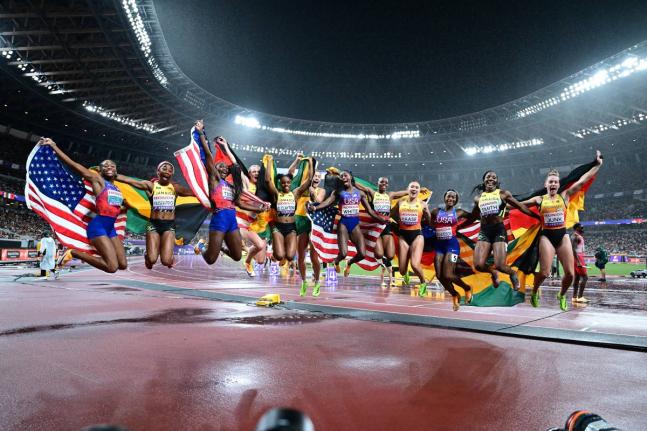 Members of the Jamaica, United States and Germany teams celebrate after winning the medals in the women’s 4x100m final. The US took gold ahead of Jamaica, followed by Germany.