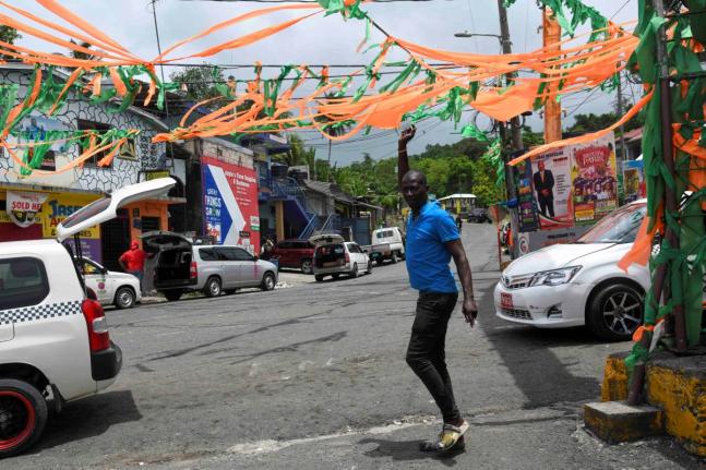 In this June 26, 2025 photo, a man walks through a cluttered Gayle square in St Mary.