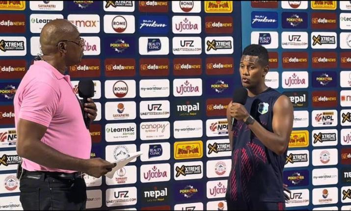 West Indies stand-in captain Ackeal Hosein (right) speaks to commentator and former West Indies fast bowler, Ian Bishop after his side completed a 10-wicket win over Nepal in the third T20I at the Sharjah Cricket Stadium on Tuesday.