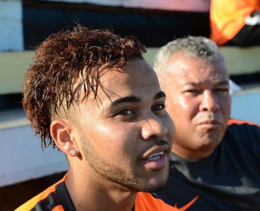 Kyle Butler (left) speaks as his father Craig looks on in the background.