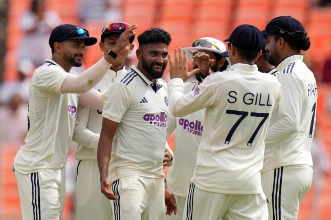India’s Mohammed Siraj (centre)  celebrates with teammates after the dismissal of West Indies’ Brandon King on the first day of the first Test  at Narendra Modi Stadium in Ahmedabad, India yesterday.
