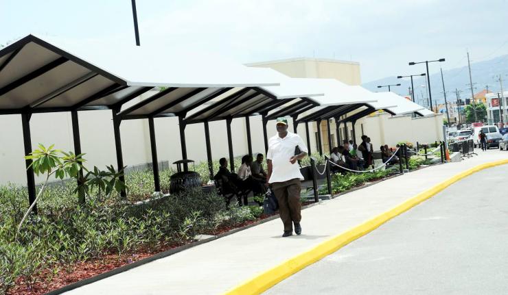 Visa applicants sit outside the United States Embassy in St Andrew.