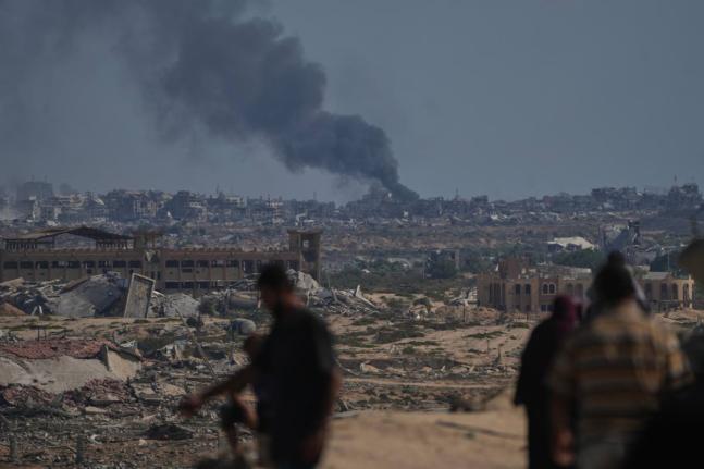 Smoke rises to the sky following an Israeli military strike in Gaza City, as seen from the central Gaza Strip, Thursday, October 2, 2025. (AP Photo/Abdel Kareem Hana)