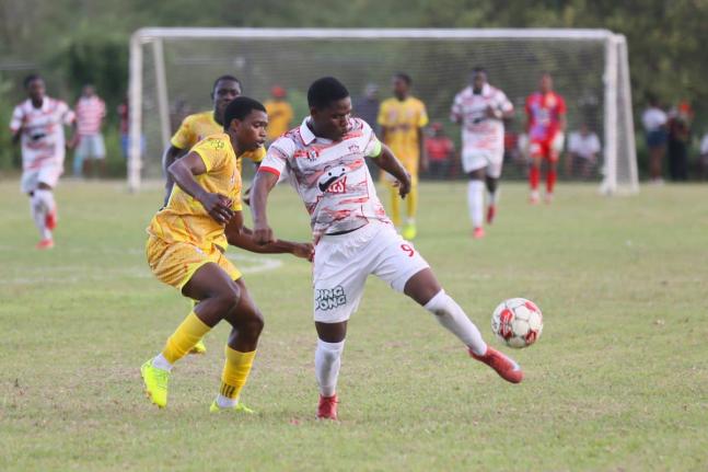 Glenmuir High’s Orane Watson (right) and  Garvey Maceo High’s  Ajani Johnson battle for the ball during their  top-of-the-table clash at Garvey Maceo on Tuesday, September 30. Glenmuir won 4-0. 