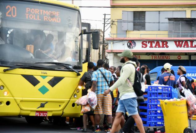 In this file photo commuters are seen jostling to board a Jamaica Urban Transit Company bus at the South Parade terminus in downtown Kingston.
