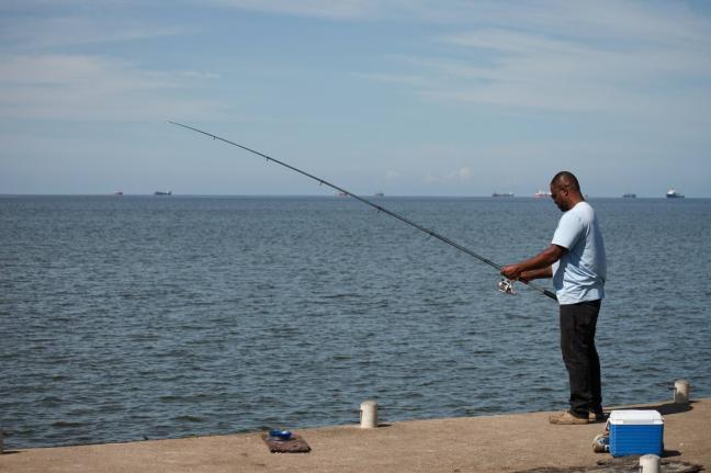 A man fishes in Cocorite, Trinidad and Tobago.