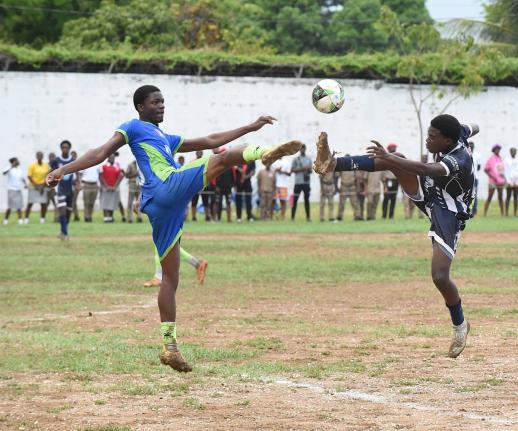 Vauxhall High School’s Serani Brown (left) and Jamaica College’s Gervair Grant fight for possession duing their ISSA/WATA Manning Cup Zone C clash at Vauxhall on Friday. The game ended 1-1.