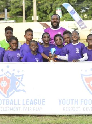 St Peter and Paul under-11 team celebrates winning the Youth Football League’s Junior Cup Urban Championship at the Constant Spring Field on Saturday. 