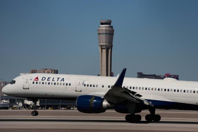 A plane lands at Harry Reid International Airport, Tuesday, October 7, 2025, in Las Vegas. (AP Photo/John Locher)