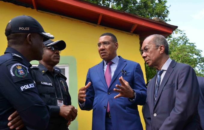 Prime Minister Dr Andrew Holness (second right) in dialogue with Deputy Prime Minister and  Minister of National Security, Dr Horace Chang (right), Police Commissioner, Dr Kevin Blake (left) and Assistant Commissioner of Police for Area 5,  Christopher Phi