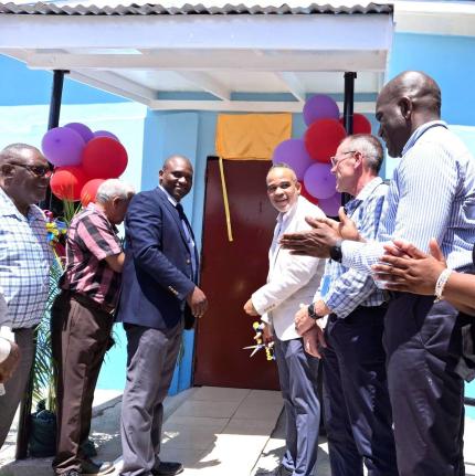 Jamalco has partnered with Bustamante High School to transform two classrooms into state-of-the-art literacy and numeracy laboratories at a cost of $2 million. In the photo, Jamalco’s Managing Director, Marvin Jackson, cuts the ribbon with Bustamante Hig