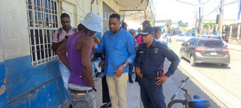 Mayor of Port Maria Fitzroy Wilson has a discussion with a fish vendor, while head of the St Mary police division, Superintendent Anthony Wallace looks on.