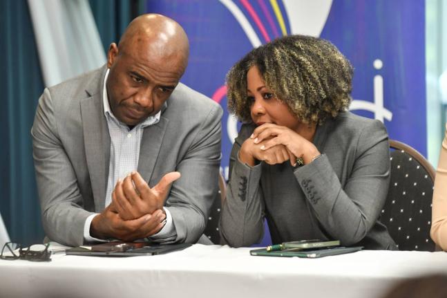 Dr Adrian Stokes (left), chairman of the Education Transformation Oversight Committee, and Education Minister Dr Dana Morris Dixon in conversation at an ETOC press conference yesterday.