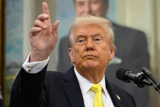 
President Donald Trump speaks during an event in the Oval Office at the White House.