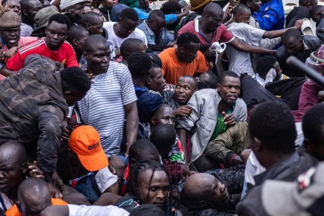 People get caught in a stampede as they attend the state funeral of former Kenya Prime Minister Raila Odinga at Nyayo National Stadium in Nairobi, Kenya, Friday, October 17, 2025. (AP Photo/Samson Otieno)