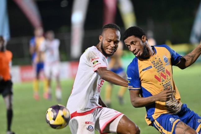 Forward Rohan Brown (right) of Harbour View and Portmore United’s defender Stephen Young battle for the ball during a Jamaica Premier League match in October.