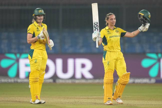 Australia’s Ashleigh Gardner (right) celebrates scoring a century as teammate Annabel Sutherland applauds during the ICC Women’s Cricket World Cup match against England at Holkar Cricket Stadium in Indore, India, yesterday.